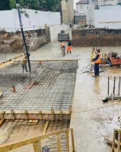 Basement construction team managing structural work below ground