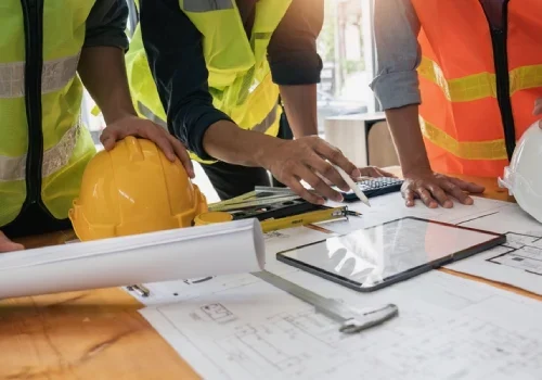 Contractor reviewing construction plans during a London residential build