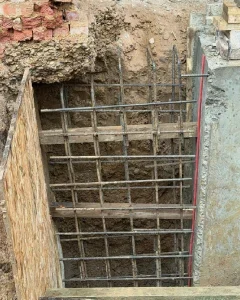 Construction team following engineering drawings for structural concrete work